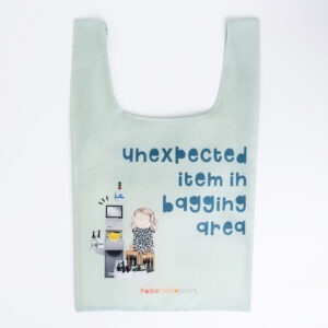 shopping bag, text reads 'unexpected item in bagging are'. image shows a woman at self checkout with mostly booze and a bunch of bananas.
