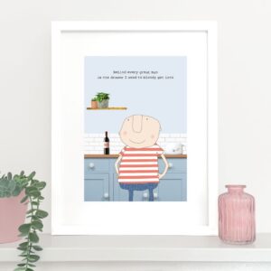 funny art print, valentine gift. picture of a man standing in front of kitchen cupboards. Caption reads ' Behind every great man is the drawer I need to bloody get in to'.