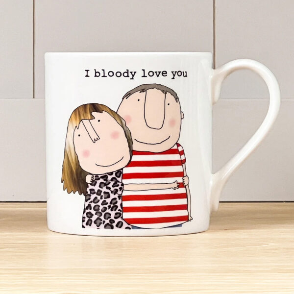 coffee mug in white with an image of a man and woman having a hug, caption reads 'I bloody love you'.
